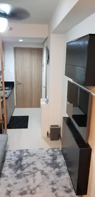a room with a kitchen with a television and a door at BayLIfe Escape in Manila