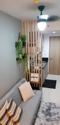a living room with a couch and a staircase at BayLIfe Escape in Manila