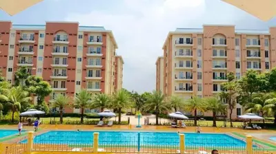 a large swimming pool in front of two large buildings at CHATEAU ELYSEE A11 Near Sm Mall and Airport in Manila
