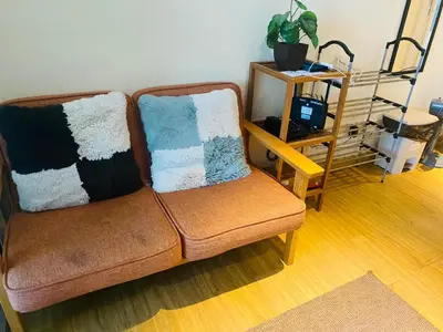 a couch with two pillows on it in a living room at Azure Urban Residence A10 Near Airport and SM Bicutan+ Free wifi in Manila