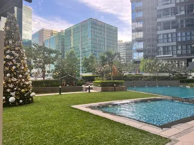 a christmas tree and a swimming pool in a city at Uptown Parksuites II in Manila