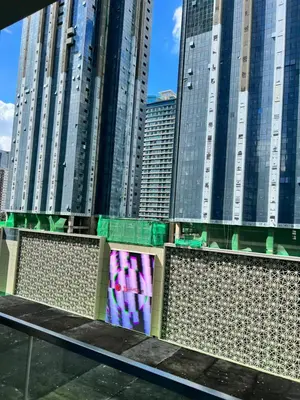 a bench in front of some tall buildings at Uptown Parksuites II in Manila