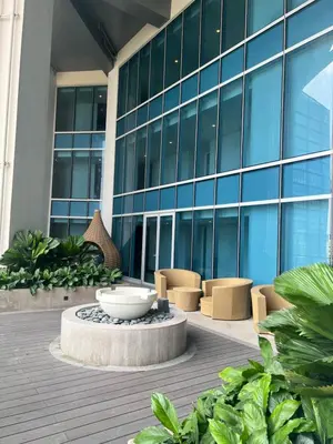 a building with a fountain in front of a building at Uptown Parksuites II in Manila