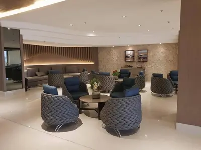 a lobby with blue chairs and a waiting room at Shore Residences MOA Complex Staycation in Manila