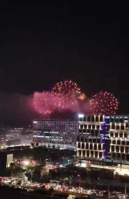 a firework display in the sky over a city at night at Condo- tel for At Mall of Asia Philippines in Manila