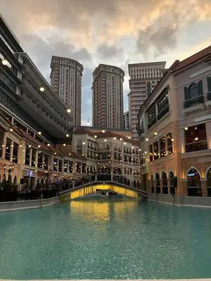 a building with a pool of water in a city at Morgan Suite BGC Shortwalk2 Venice Mall free pool gym in Manila