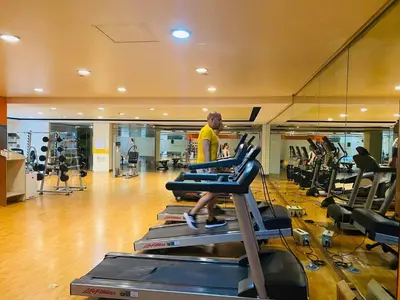 a man walking on a treadmill in a gym at Morgan Suite BGC Shortwalk2 Venice Mall free pool gym in Manila