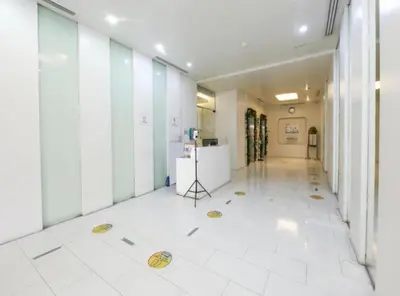 a hallway of an office with a white tile floor at Sab R. Bel air soho in Manila