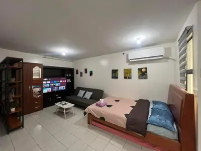 a bedroom with a bed and a couch at San Jose Residencias / enchanted kingdom / nuvali / slex / sta. rosa / paseo in Santa Rosa