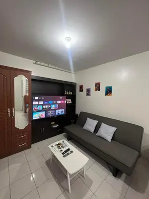 a living room with a couch and a tv at San Jose Residencias / enchanted kingdom / nuvali / slex / sta. rosa / paseo in Santa Rosa