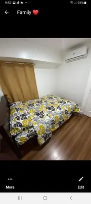a bedroom with a bed with yellow and white sheets at VICTORIA DE MAKATI Two (2) Bedroom Up and Down Condo in Manila