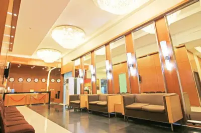 a waiting room with couches and mirrors in a building at Relaxing Big Studio Bedroom in Manila