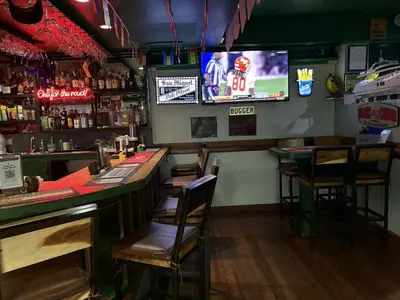 a bar with chairs and a television in a restaurant at duck inn manila in Manila