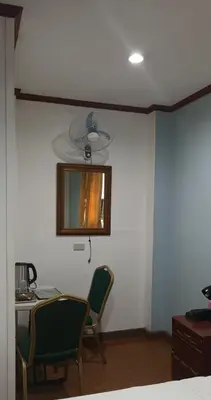 a room with a table and two chairs and a mirror at duck inn manila in Manila