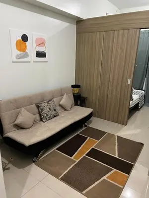 a living room with a couch in a room at 1 Bedroom lovely place near Mall of Asia in Manila