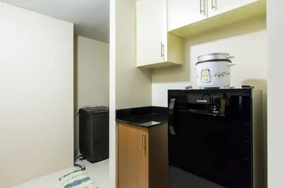 a kitchen with a black refrigerator and a blender on top of it at 2 BR Condo Apartment near NAIA 3 Pasay City in Manila