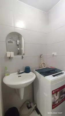 a white bathroom with a sink and a mirror at Destina Stays @Jazz Residences, Makati, Metro Manila, w/Netflix in Manila