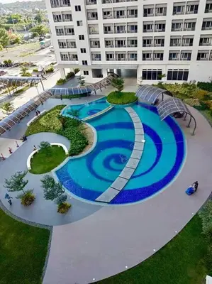 an aerial view of a swimming pool in a building at Affordable Fully Furnished Condo Unit in Manila