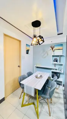a dining room with a table and chairs at Staycation in Pasig - Near SM East Ortigas in Manila