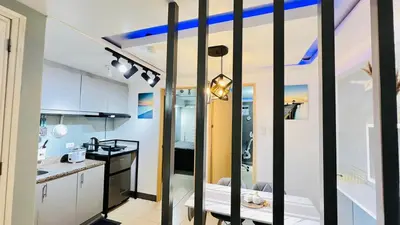 a small kitchen with black and white walls at Staycation in Pasig - Near SM East Ortigas in Manila