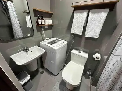 a small bathroom with a toilet and a sink at Modern Classic 1 BR Condo Air Residences Makati in Manila