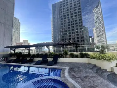 a swimming pool on the roof of a building at Poolview Family Room Greenbelt Makati in Manila