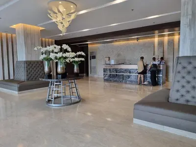 a lobby with vases of flowers on a table at Shore 3 Residences Mall of Asia Pool view Netflix free wifi in Manila