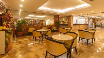 a restaurant with tables and chairs and a bar at Aloha Hotel Roxas Boulevard Manila in Manila