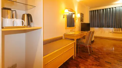 a room with a desk and a computer in a room at Aloha Hotel Roxas Boulevard Manila in Manila