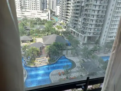 a view of a swimming pool from a hotel window at Bunked Bed Room Sharing in Manila