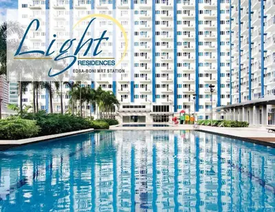 a large swimming pool in front of a large building at StayHere SM Light by Boni MRT along EDSA in Manila