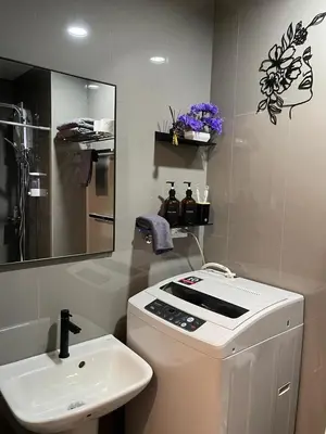 a bathroom with a toilet and a sink and a mirror at Amazing view Makati Elegant flat 400MB internet in Manila