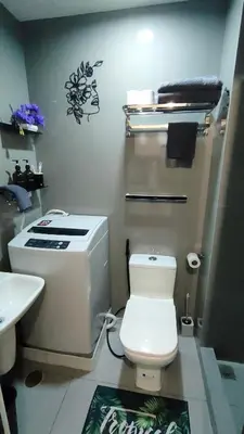 a bathroom with a white toilet and a sink at Amazing view Makati Elegant flat 400MB internet in Manila