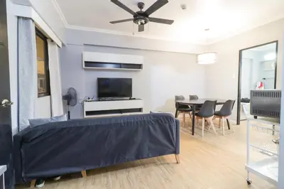 a living room with a bed and a dining room at StayHere - Nordic Design 2BR Serviced Apartment in Manila
