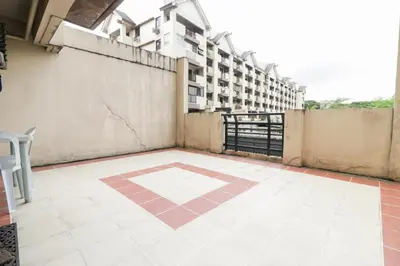a balcony with a tile floor and a building at StayHere - Nordic Design 2BR Serviced Apartment in Manila