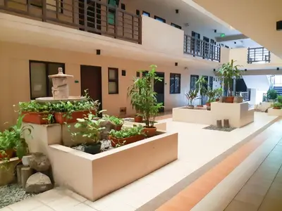 a lobby with potted plants in a building at StayHere - Nordic Design 2BR Serviced Apartment in Manila