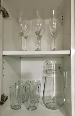 a row of wine glasses sitting on a shelf at Daniella’s Modern & Cozy Suite in Uptown BGC in Manila