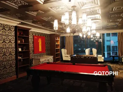 a room with a pool table and a chandelier at The Knightsbridge Residences in Manila