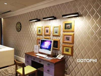 a computer on a desk with pictures on the wall at The Knightsbridge Residences in Manila