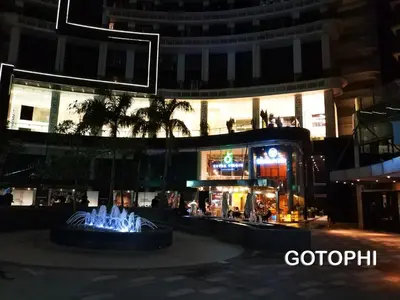 a fountain in front of a building at night at The Knightsbridge Residences in Manila