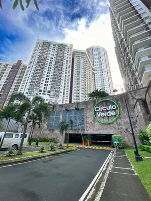 a street in front of a building with a sign on it at Fully furnished condo in Quezon City in Manila