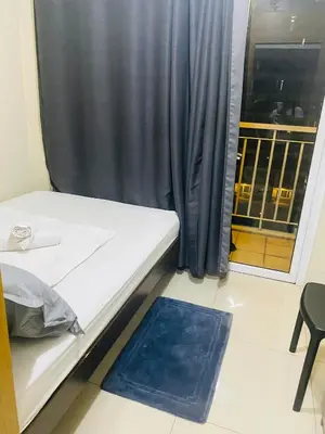 a bed in a room with a window and a mat at Shell Residences C16 Shortwalk Sm Mall Of Asia/Airport in Manila