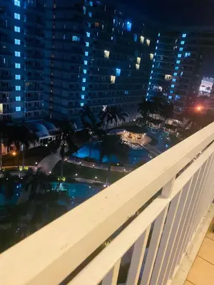 a view from the balcony of a building at night at Shell Residences C16 Shortwalk Sm Mall Of Asia/Airport in Manila