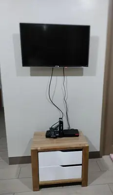 a flat screen tv sitting on top of a table at Room Across NAIA Terminal 3 at Newport in Manila