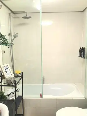 a bathroom with a shower and a bath tub at McKinley Hill, BGC 3 Bedroom Unit Venice Mall Walking Distance in Manila