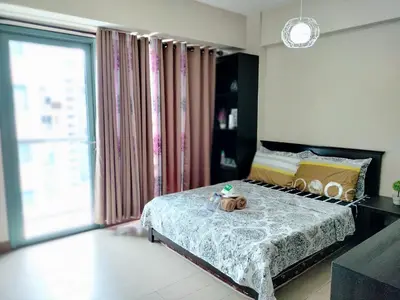a bedroom with a bed with a stuffed animal on it at Condotel Pasay Newport Near Airport in Manila