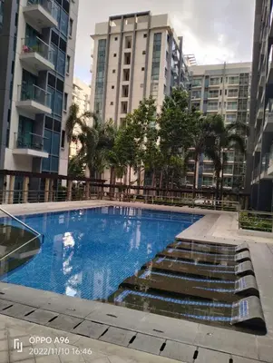 a swimming pool in a city with tall buildings at Condotel Pasay Newport Near Airport in Manila
