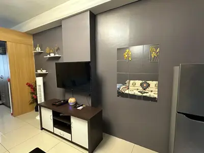 a living room with a flat screen tv on a wall at Kathys crib 32sqm Condo Shell Residences in Manila