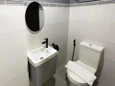 a bathroom with a white toilet and a sink at mySTAY Hotel BGC South in Manila