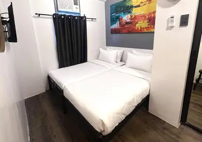 a small bedroom with a white bed in it at mySTAY Hotel BGC South in Manila